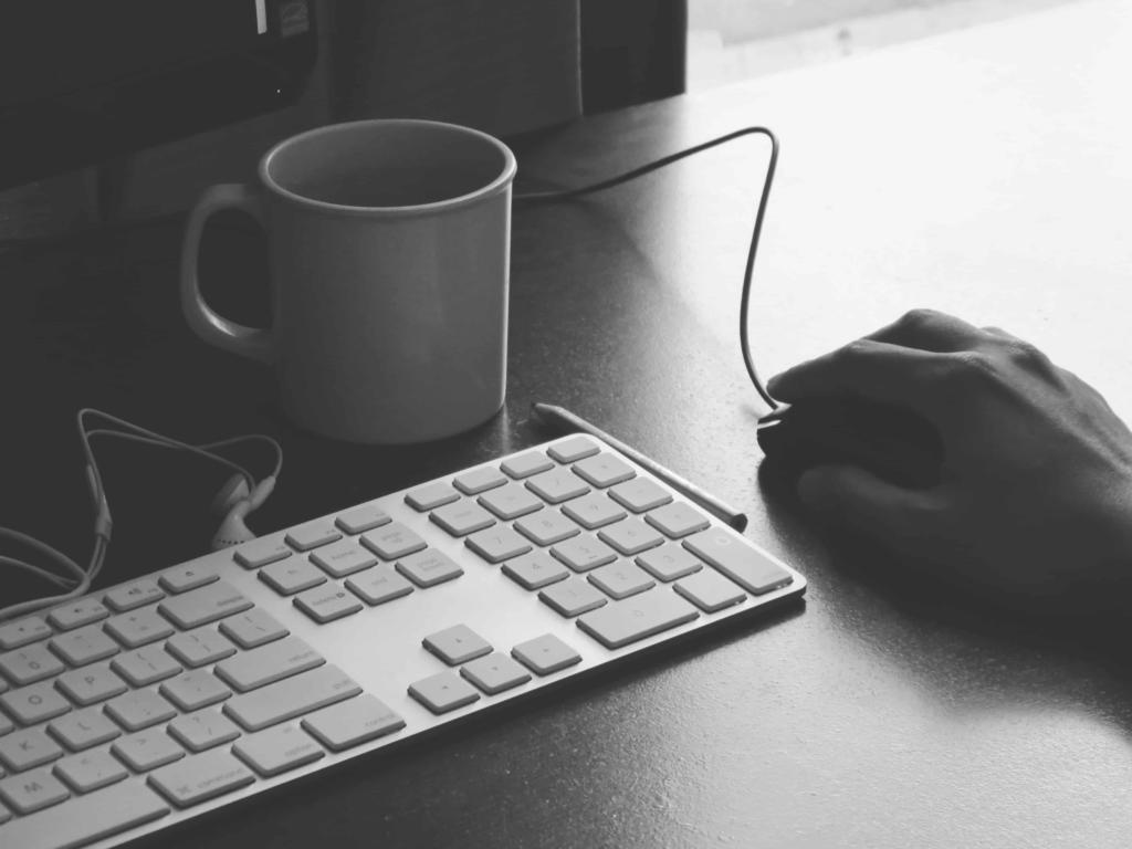 Desk, with keyboard, and user working on keyword match type selection
