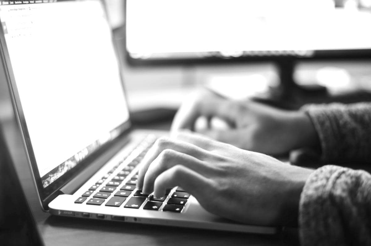 User On Laptop Writing PPC Landing Page Copy