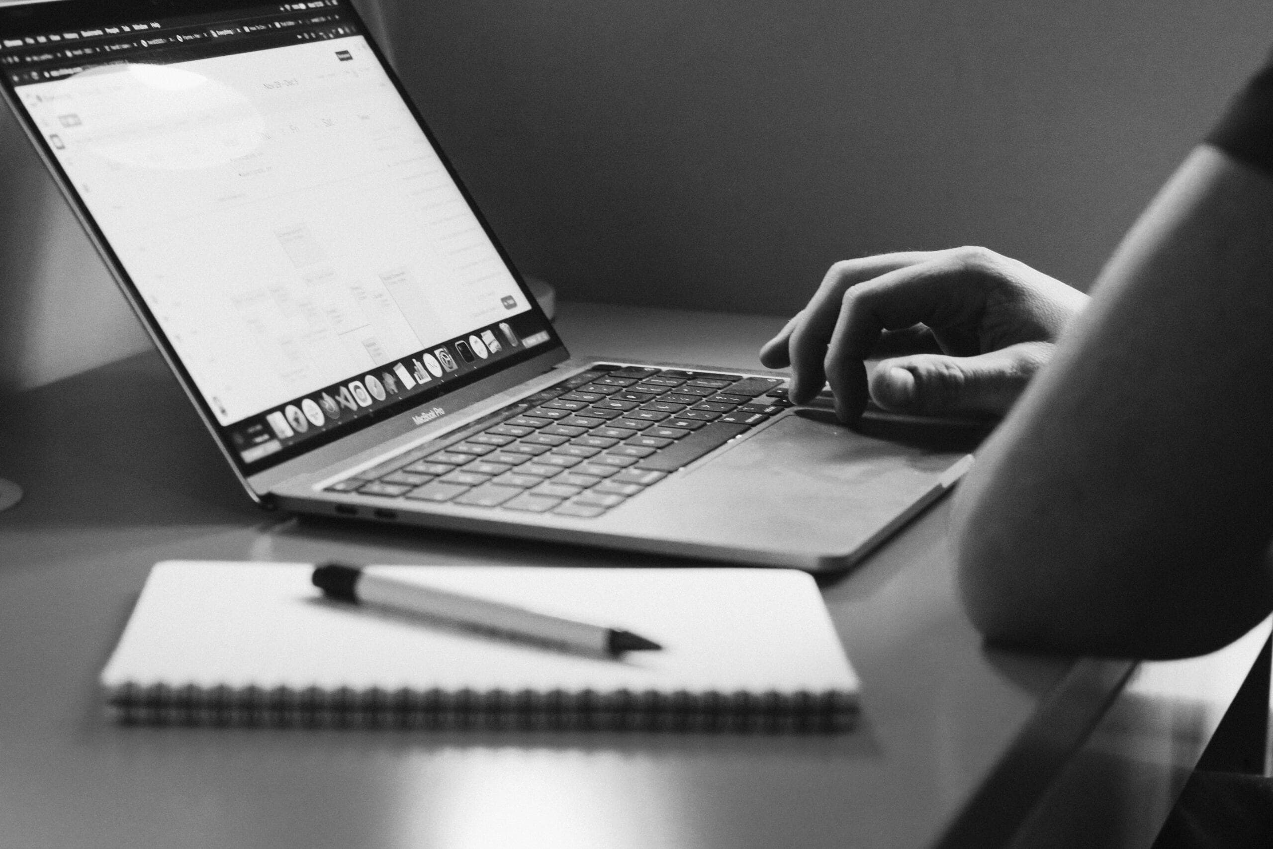 Email list on a laptop screen, office background