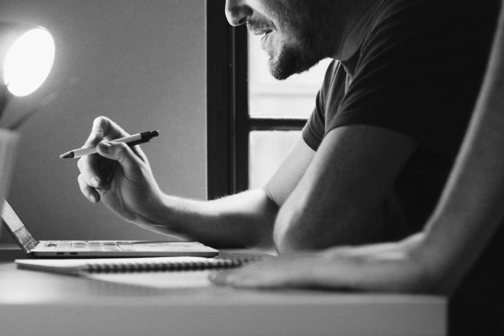 Email Marketing specialist working on a computer in an office