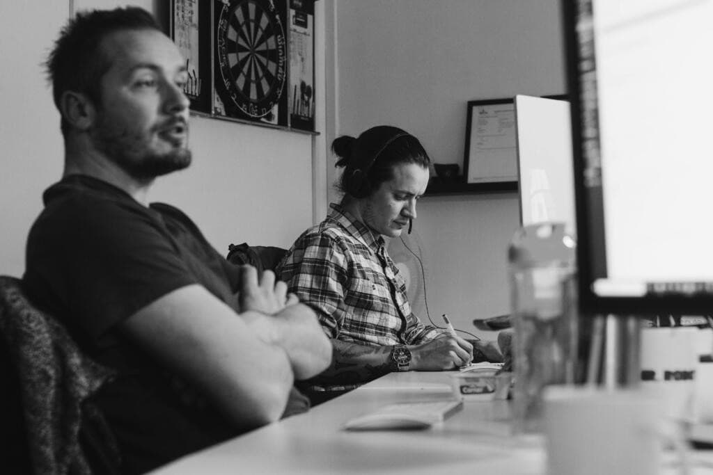 Close-up image of strategy team discussing working calendar for a month on laptop screen