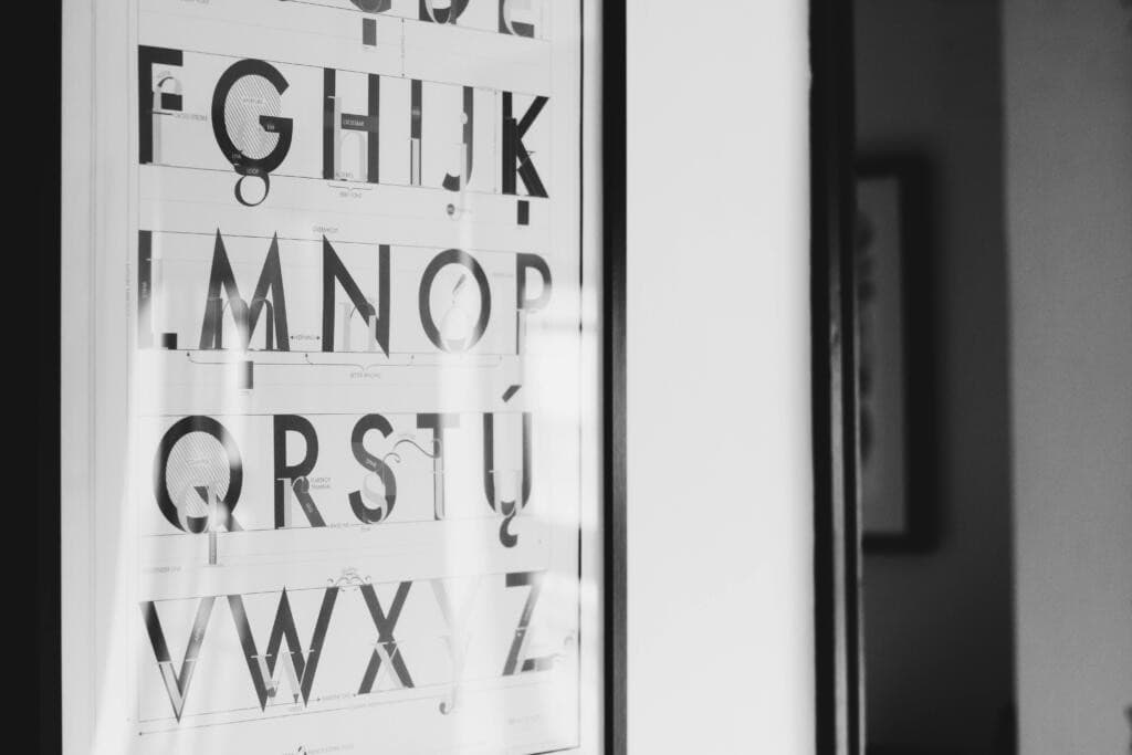 Black and white framed alphabet poster on a wall, highlighting typography details to illustrate content chunking for SEO and GEO.